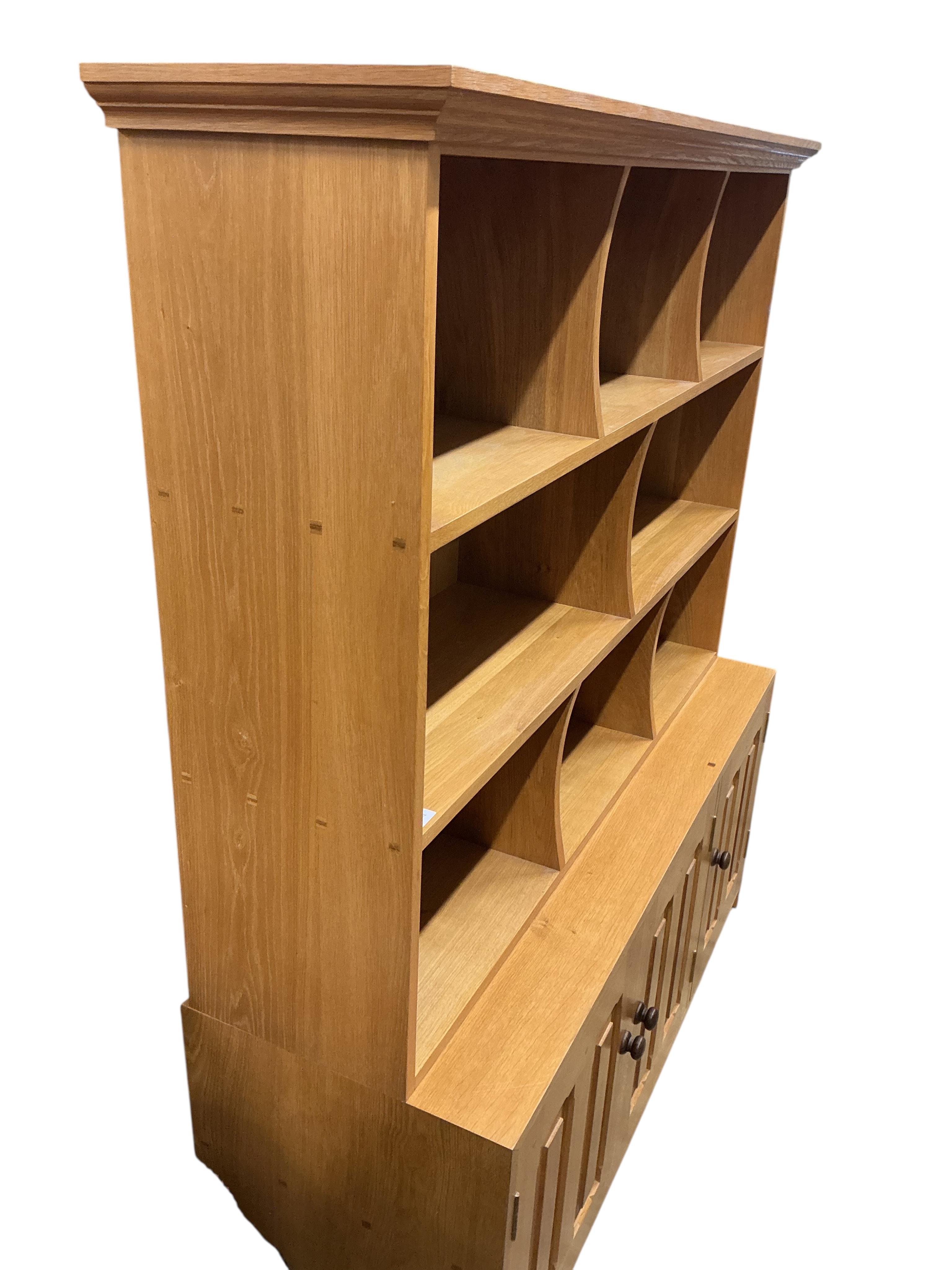 A Contemporary bespoke oak open bookcase, cupboards below, width 141cm, depth 46cm, height 169cm